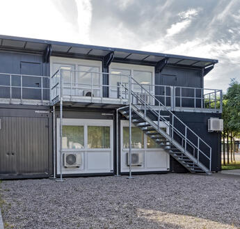 Rückseitig gelangt man über eine Treppe und Dachterrasse in die obere Etage der ELA Anlage.