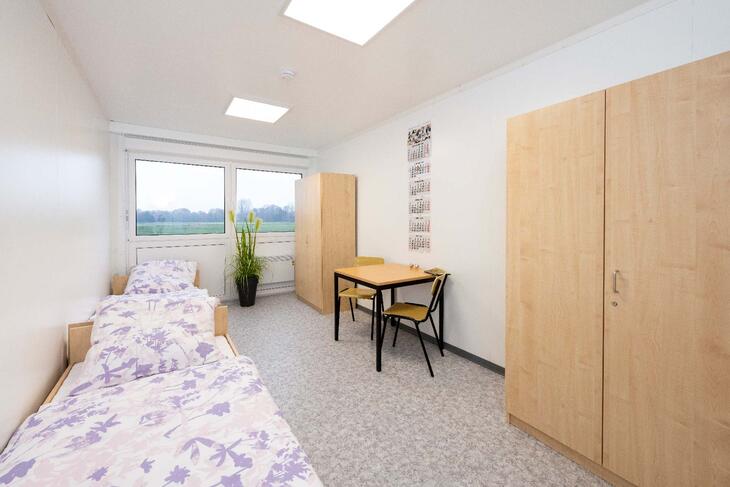 Wohncontainer innen mit Bett, Tisch und Schrank Wohncontainer innen mit Bett, Tisch und Schrank